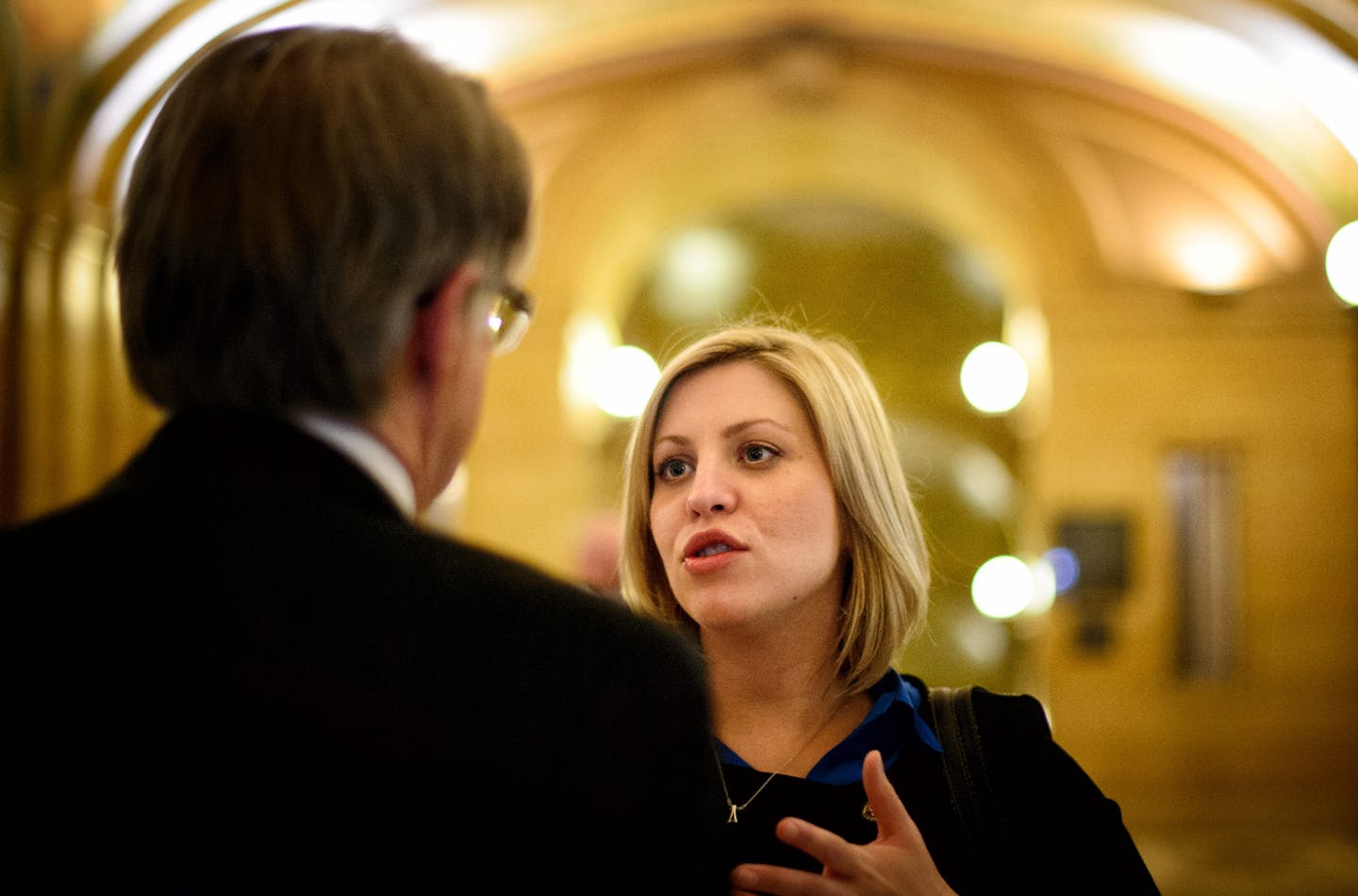 On her way to meet with Sen. Sandra Pappas office, Rep. Carly Melin paused to talk with Department of Labor and Industry Commissioner Ken Peterson about a provision of her Women's Economic Security Act. ] Wednesday, April 30, 2014 GLEN STUBBE * gstubbe@startribune.com