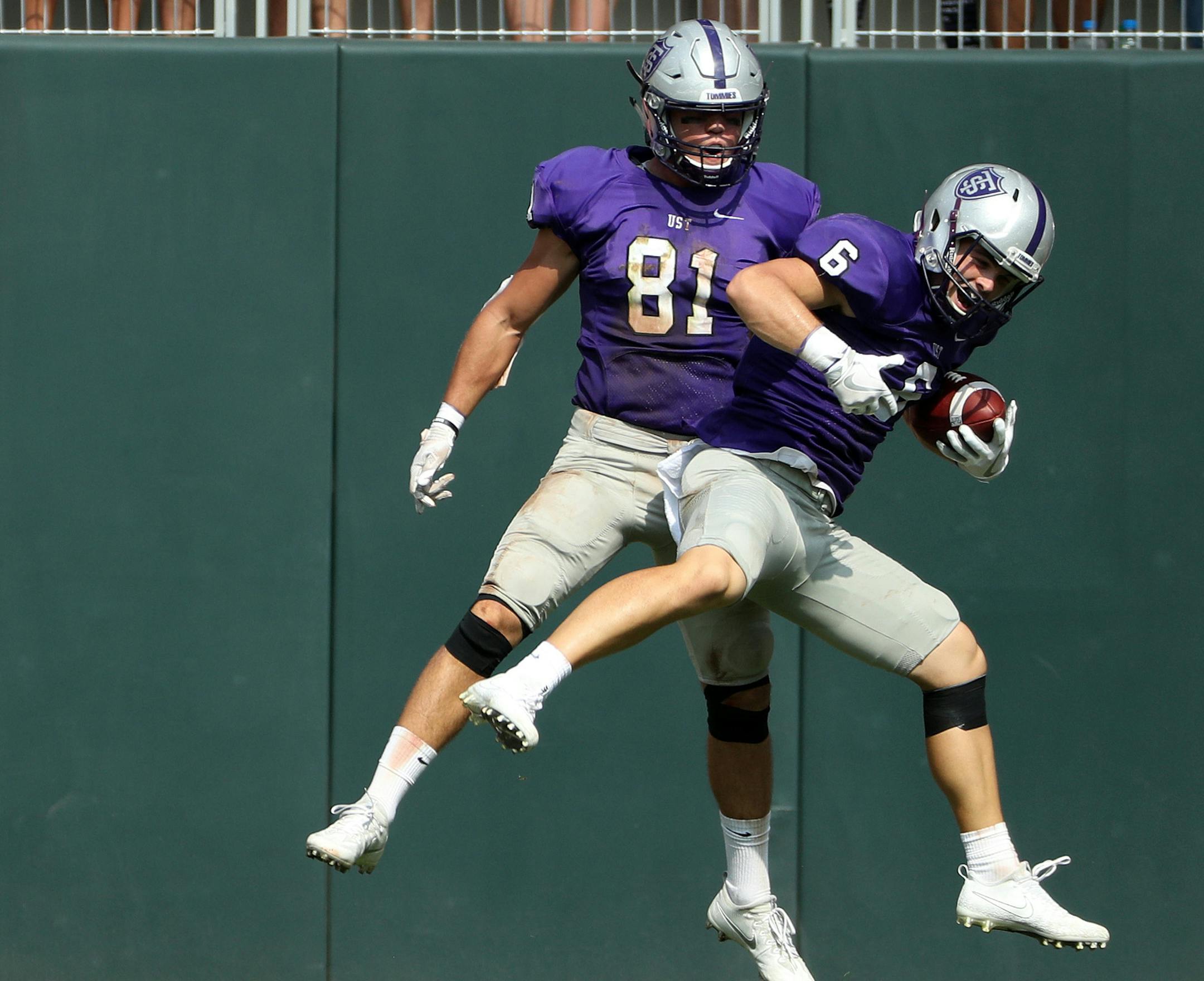 University of St. Thomas's Gabe Green (6) celebrated with University of St. Thomas tight end Grant Slavik (81) after scoring a touchdown in the first half. ] ANTHONY SOUFFLE &#xef; anthony.souffle@startribune.com Game action from an NCAA football game between the University of St. Thomas and St. John's University Saturday, Sept. 23, 2017 at Target Field in Minneapolis. ORG XMIT: MIN1709231652500141
