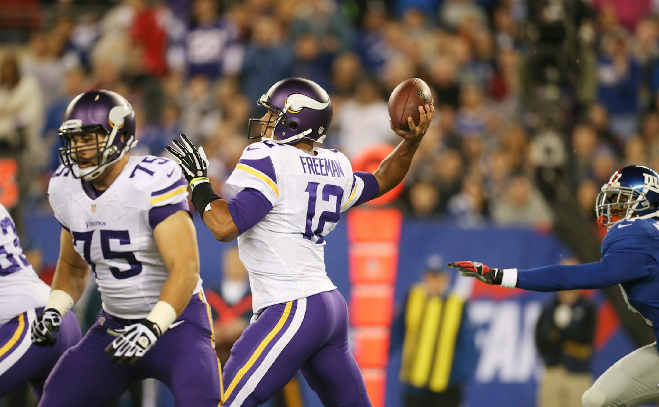 Minnesota Vikings quarterback Josh Freeman (12) threw his first complete pass to Jerome Simpson for a nine yard gain in the first quarter against the Giants.
