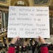 People protest the legislature's extraordinary session during the official Christmas tree lighting ceremony at the Capitol in Madison, Wis., Tuesday, 