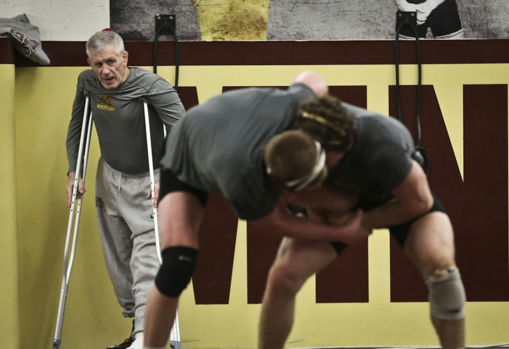 Gophers coach J Robinson coached on crutches during practice on Wednesday.