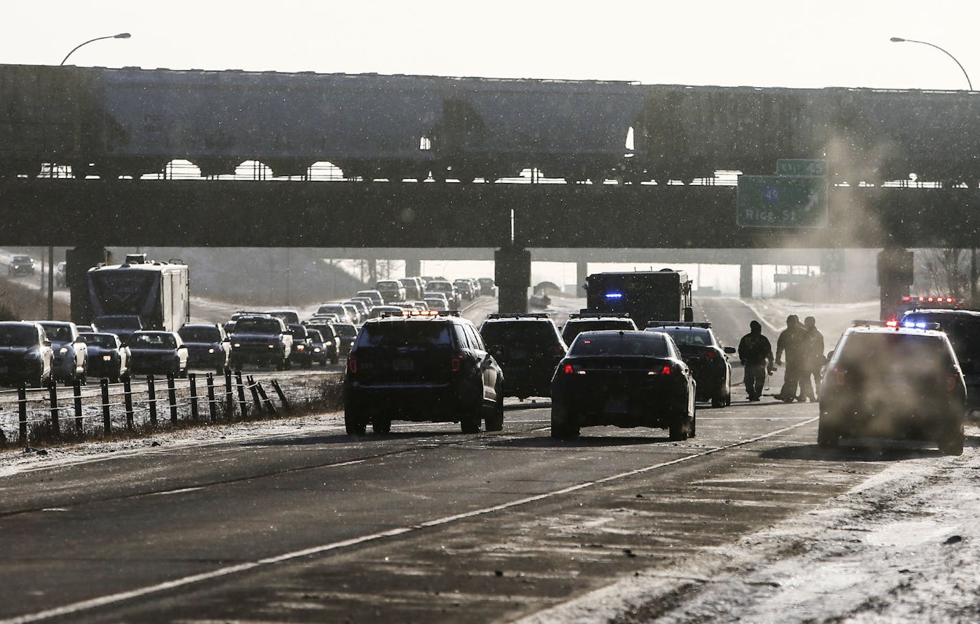 The investigation scene after an early morning car chase for a shooting suspect at a rest area in Maple Grove that left one dead concluded on I-694 near Rice Street in Shoreview, MN, Wednesday, Dec. 17, where the fleeing suspect was shot and killed by authorities. Here, traffic flows slowly in the westbound lane of I-694.](DAVID JOLES/STARTRIBUNE)djoles@startribune.com The chase for a shooting suspect at a rest area in Maple Grove that left one dead, concluded on I-694 near Rice Street in Shorev