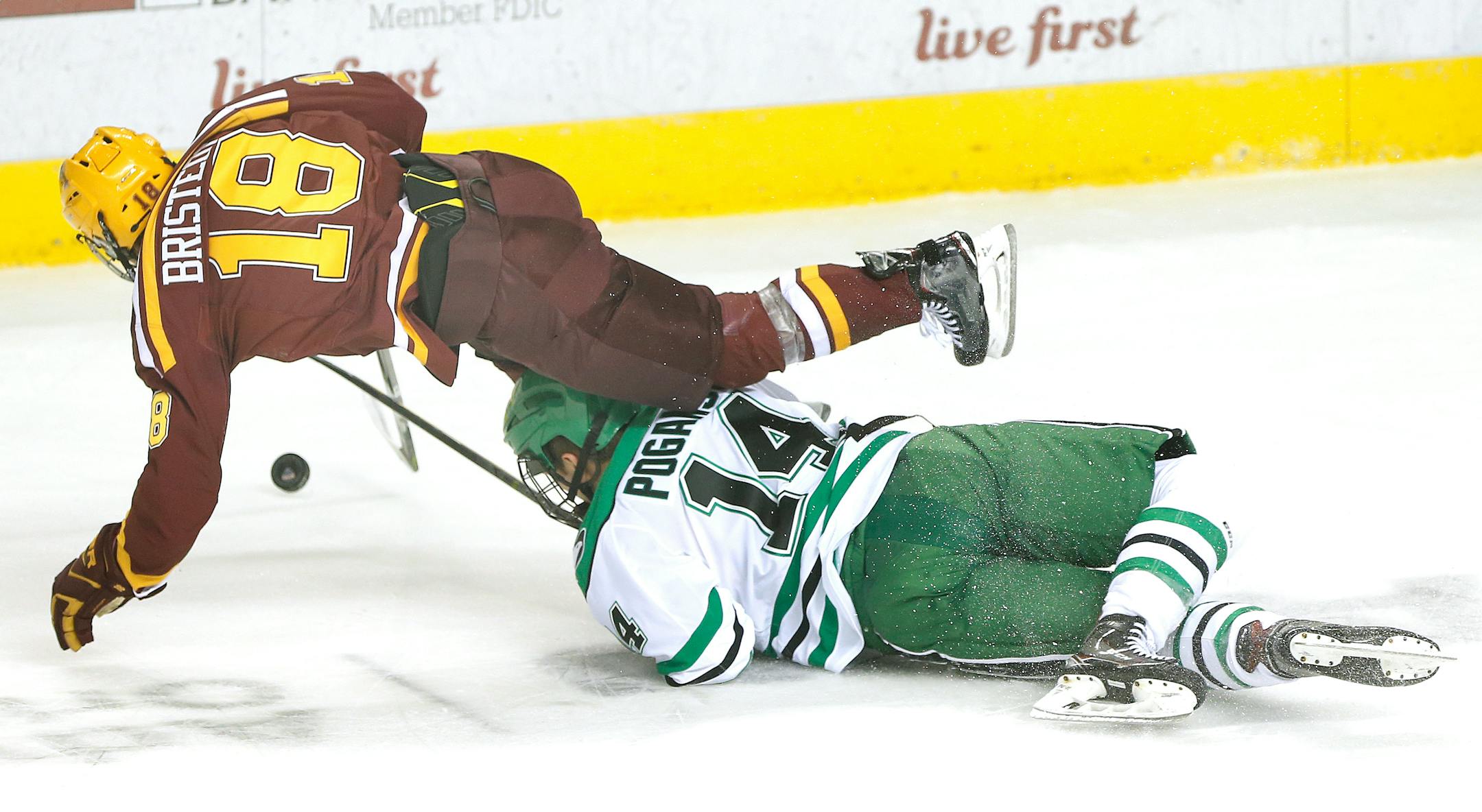 Minnesota's Leon Bristedt is upended by UND's Austin Poganski in the first period Friday at the Ralph Engelstad Arena in Grand Forks.