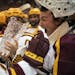 Minnesota Gophers forward Brannon McManus, left, handed the trophy to goalie Jack LaFontaine after the Gophers' Mariucci Classic win.
