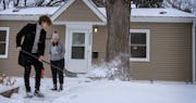 Kenley Johnson watched as her brother Benton Johnson shoveled outside her house in the Columbia Park neighborhood of Minneapolis, one of the most affo