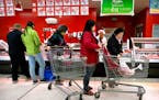 Customers shop for pork at a supermarket in Beijing, Friday, March 23, 2018. China announced a $3 billion list of U.S. goods including pork, apples an