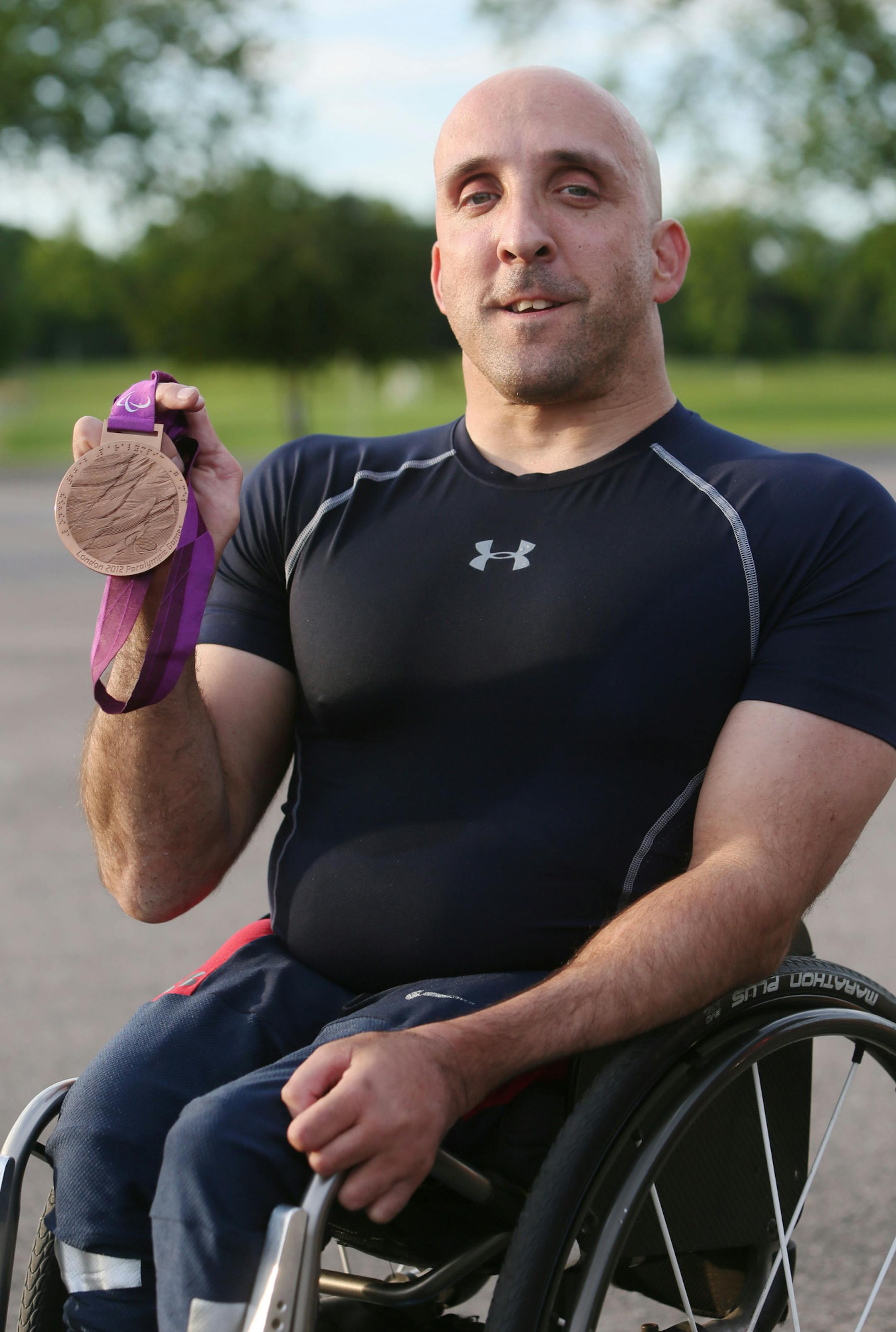 Paul Nitz, 46, a five-time Paralympian who grew up in Minnesota and has won four Paralympic gold medals in wheelchair sprints. Nitz, seen with a medal from the London Paralympic Games, moved away from Minnesota and recently moved back and is training for next year's Paralympics in Rio Di Janeiro and was seen Friday, June 12, 2015, at the Mound-Westtonka High track in Minnetrista, MN. ](DAVID JOLES/STARTRIBUNE)djoles@startribune.com Paul Nitz, a five-time Paralympian who grew up in Minnesota and