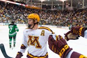 Gophers defenseman Jackson LaCombe (2) celebrated a goal in last Friday’s overtime victory against North Dakota. Minnesota plays at Ohio State this 