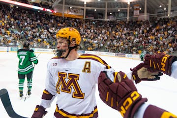 Gophers defenseman Jackson LaCombe (2) celebrated a goal in last Friday’s overtime victory against North Dakota. Minnesota plays at Ohio State this 