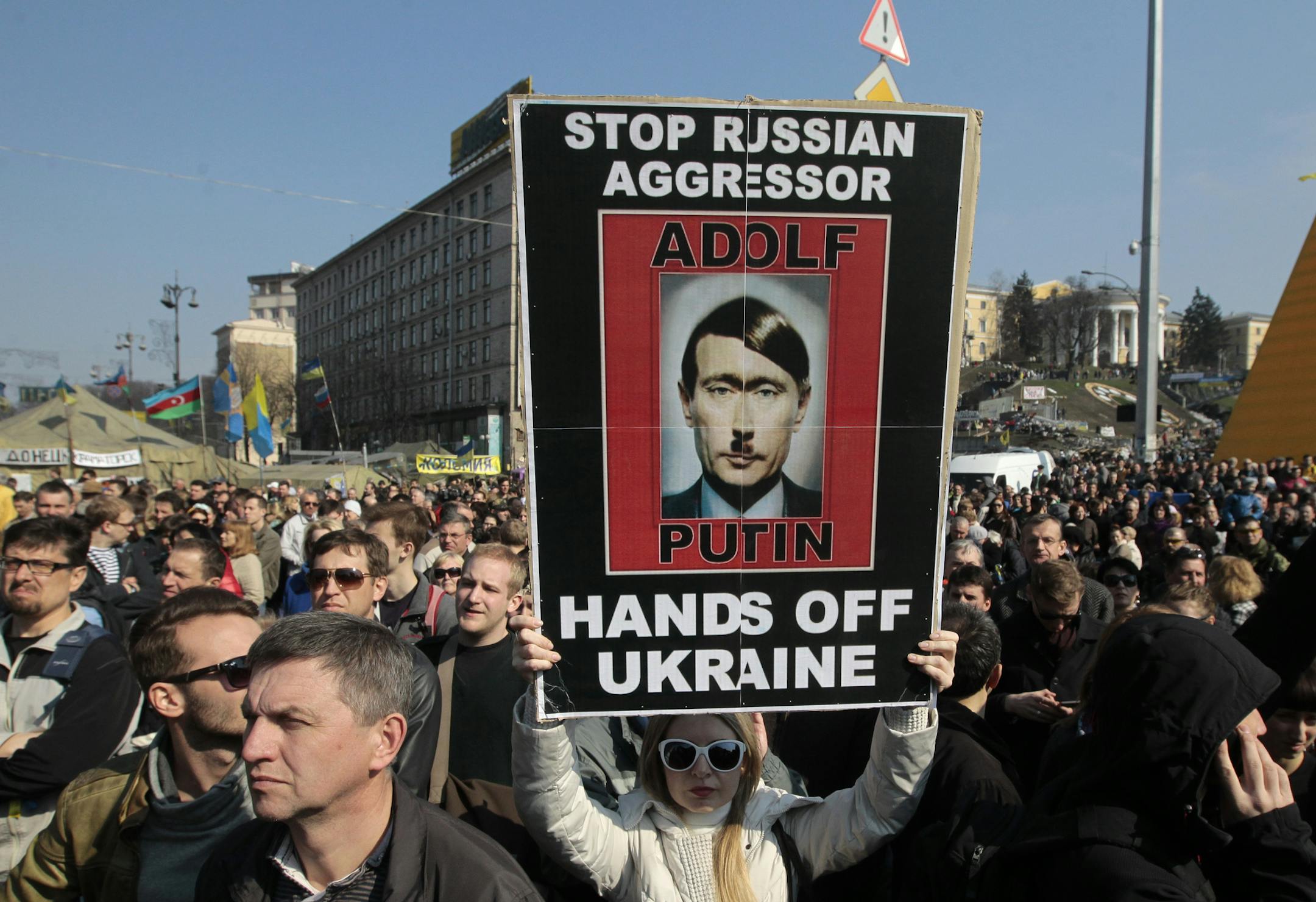 People rally in support of Ukraine's territorial integrity, in Kiev's Independence Square, Ukraine, Sunday, March 23, 2014. Thousands of demonstrators gathered on Kiev's Independence Square Sunday for a weekly rally in support of a united Ukraine and against the aggression of the Russian Federation. (AP Photo/Sergei Chuzavkov)