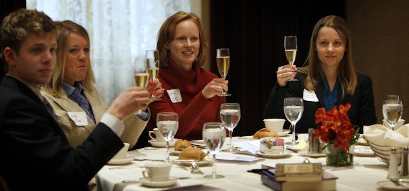 Gunnar and Molly Dancer, Karen Kaphingst and Laura Klein raised their glasses while learning the proper way to toast.