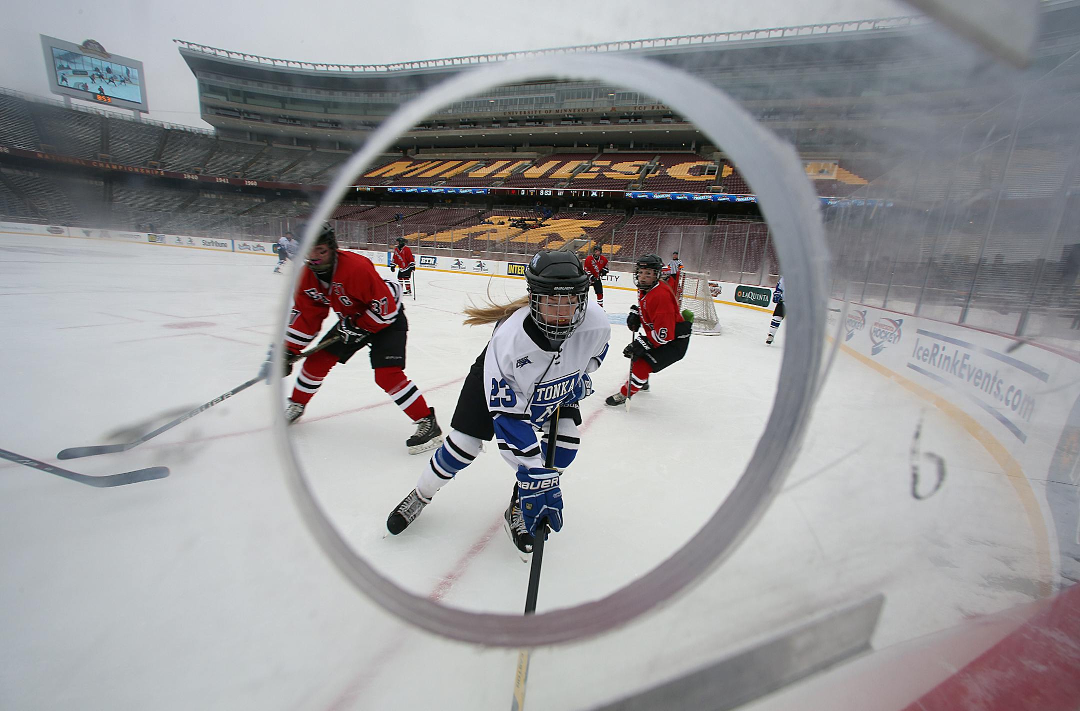 Minnetonka&#x2019;s Sara Holmgren, center, chased a loose puck as Eden Prairie&#x2019;s Anna Johnson, left, and Lauren Boyle defended on the play during a outdoors hockey game at TCF Bank Stadium.