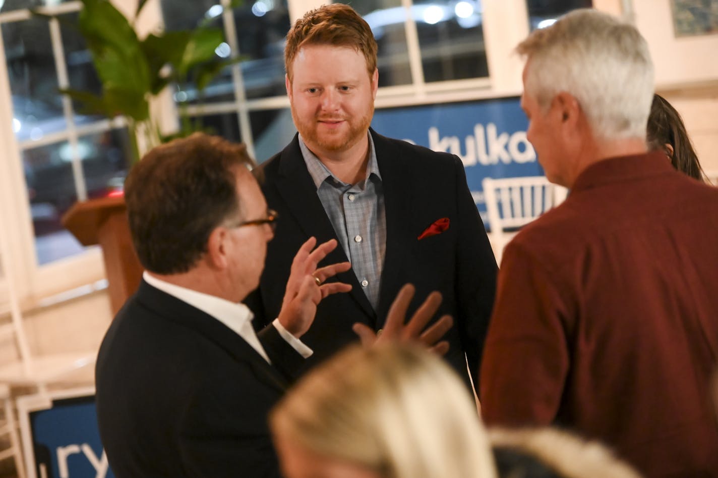 Bloomington Mayoral candidate Ryan Kulka, center, spoke to his father Greg, left and family friend Greg Jorgensen, right, during Kulka's election night watch party.