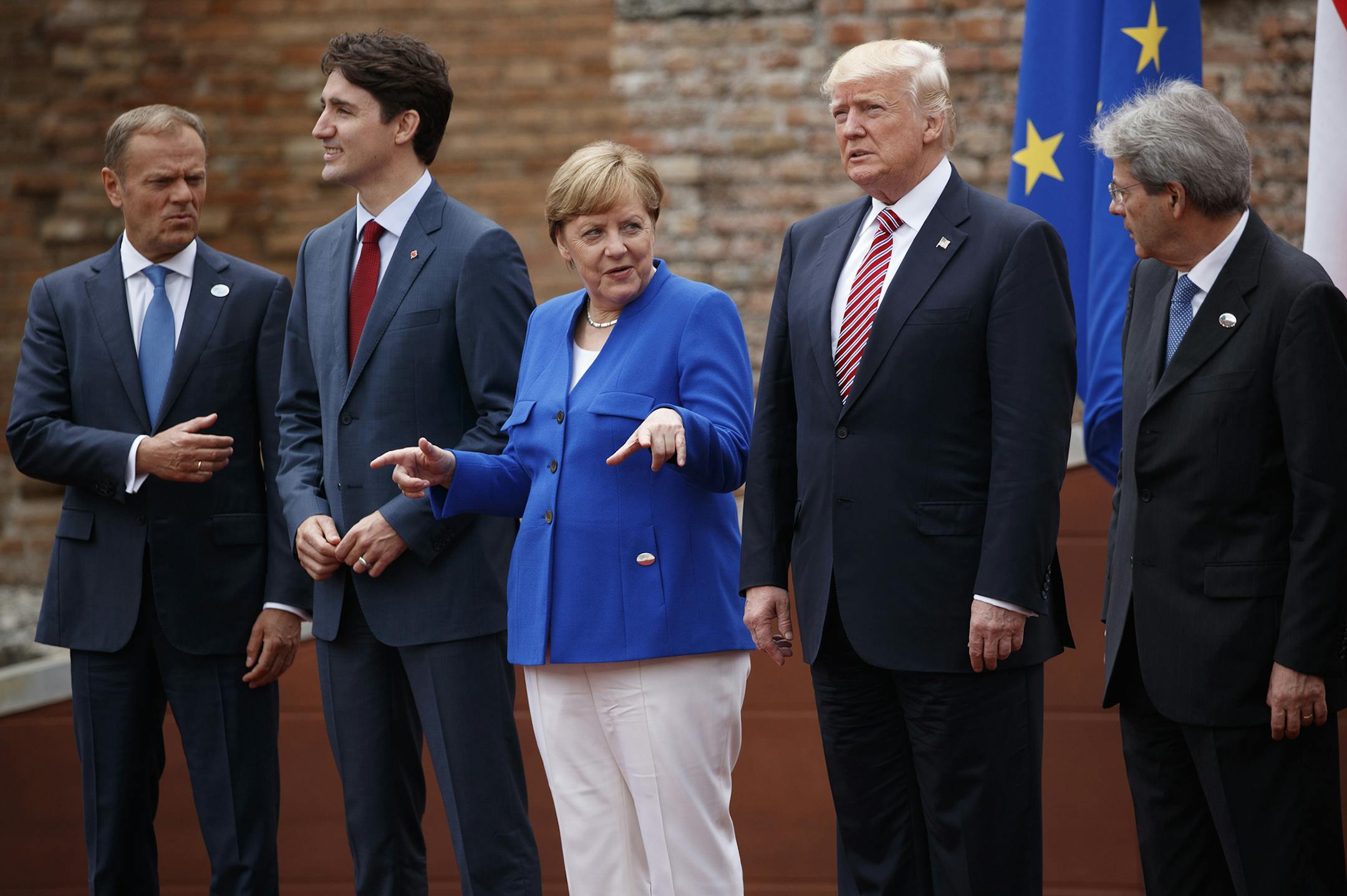 G7 leaders, from left, President of the European Commission Jean-Claude Junker, Canadian Prime Minister Justin Trudeau, German Chancellor Angela Merkel, President Donald Trump, and Italian Prime Minister Paolo Gentiloni, pose for a family photo at the Ancient Greek Theater of Taormina, Friday, May 26, 2017, in Taormina, Italy. (AP Photo/Evan Vucci) ORG XMIT: ITAV147