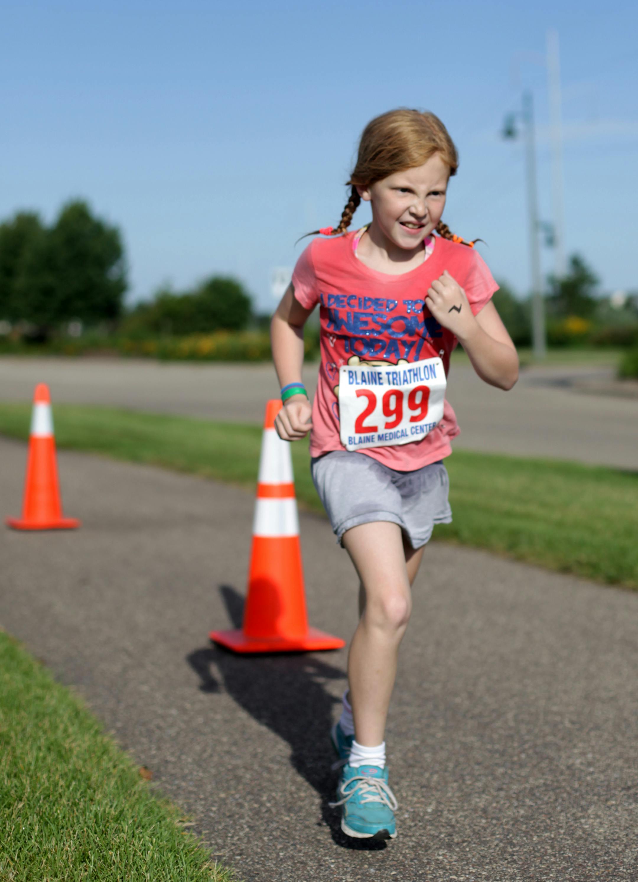 Macie McNiff, 10, begins the 1 mile run in the Kid's Triathlon on Saturday morning at Lakeside Commons Park in Blaine. ] Blaine hosted their first Kid's Triathlon on Saturday morning at Lakeside Commons Park. The competitors completed a 165 yard swim, 2.3 mile bike ride, and 1 mile run. MONICA HERNDON monica.herndon@startribune.com Blaine MN 07/26/14