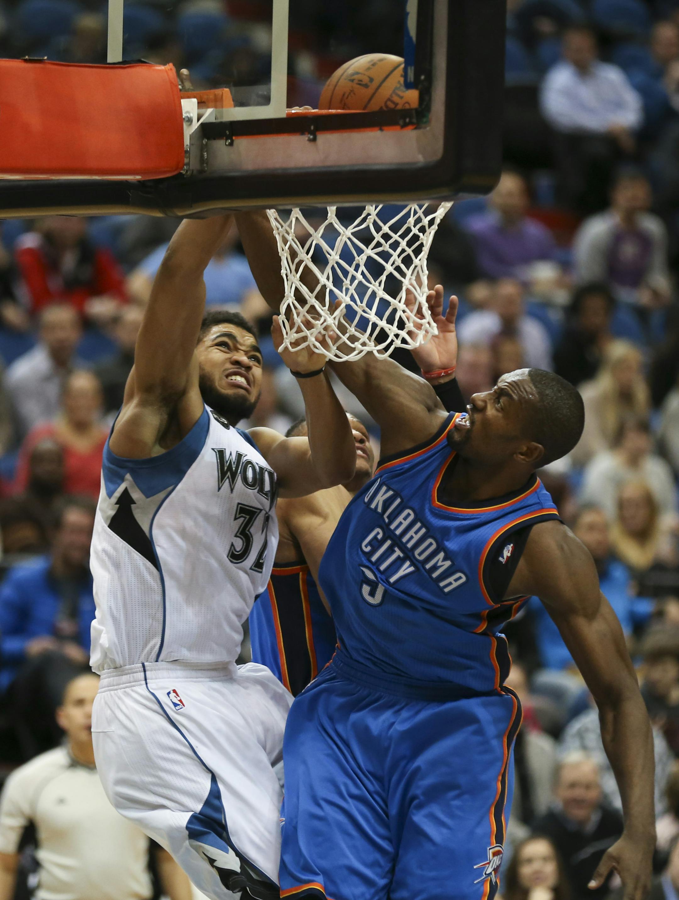 Timberwolves center Karl-Anthony Towns (32) stuffed a fourth quarter shot over the defense of Oklahoma City Thunder forward Serge Ibaka (9) and was fouled in the process Wednesday night. ] JEFF WHEELER ï jeff.wheeler@startribune.com The Minnesota Timberwolves lost 126-123 to the Oklahoma City Thunder in an NBA game Wednesday night, January 27, 2016 at Target Center in Minneapolis.