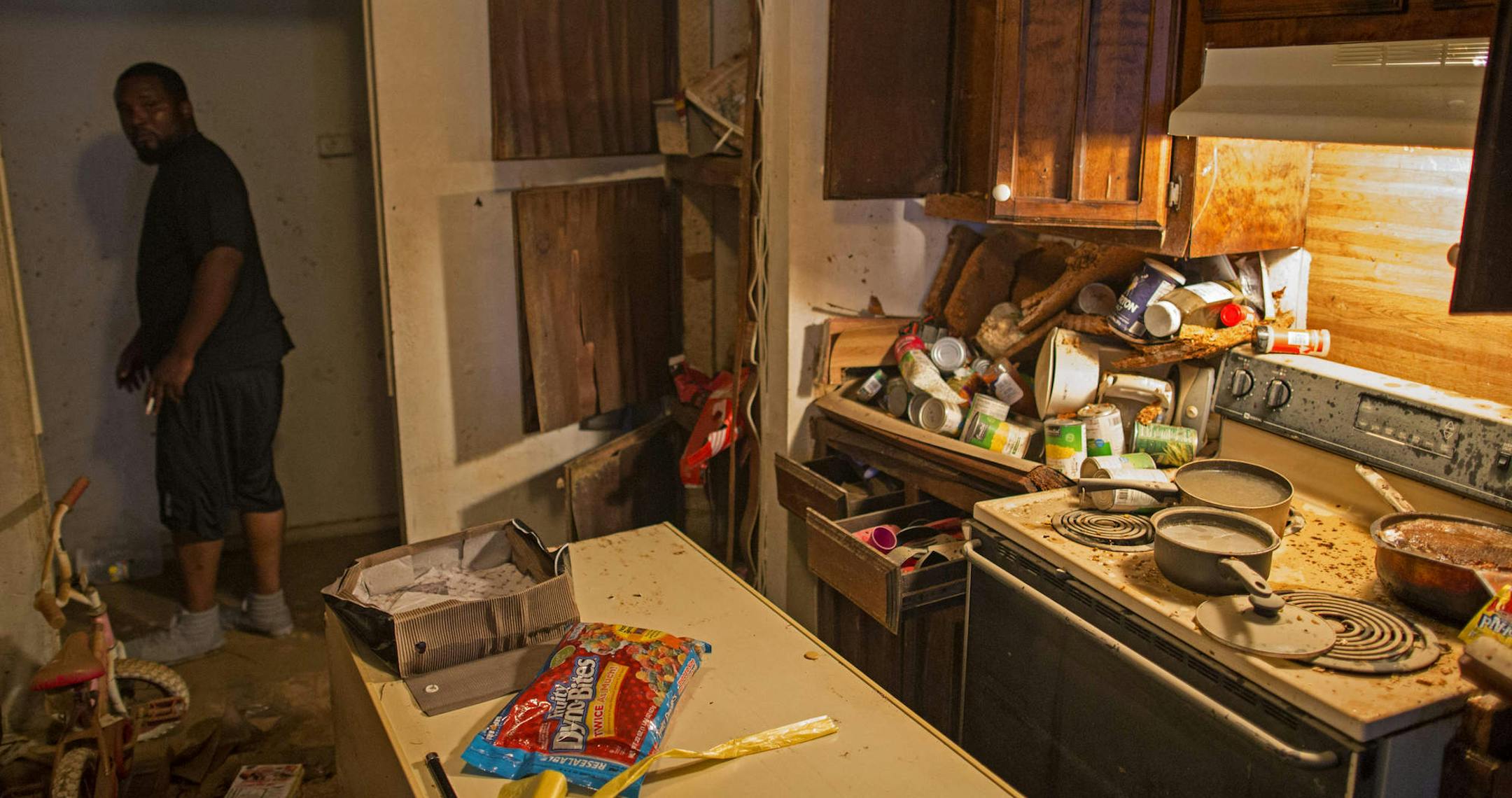 Terrance Carter, a tow truck driver and a father of four, checks out his flood-ravaged home in Baton Rouge, La., Aug. 17, 2016. The historic flooding is only the latest blow in a long summer of crisis in Baton Rouge, still reeling from the fatal shooting of Alton Sterling — Carter’s uncle — and three police officers days later. (Max Becherer/The New York Times)
