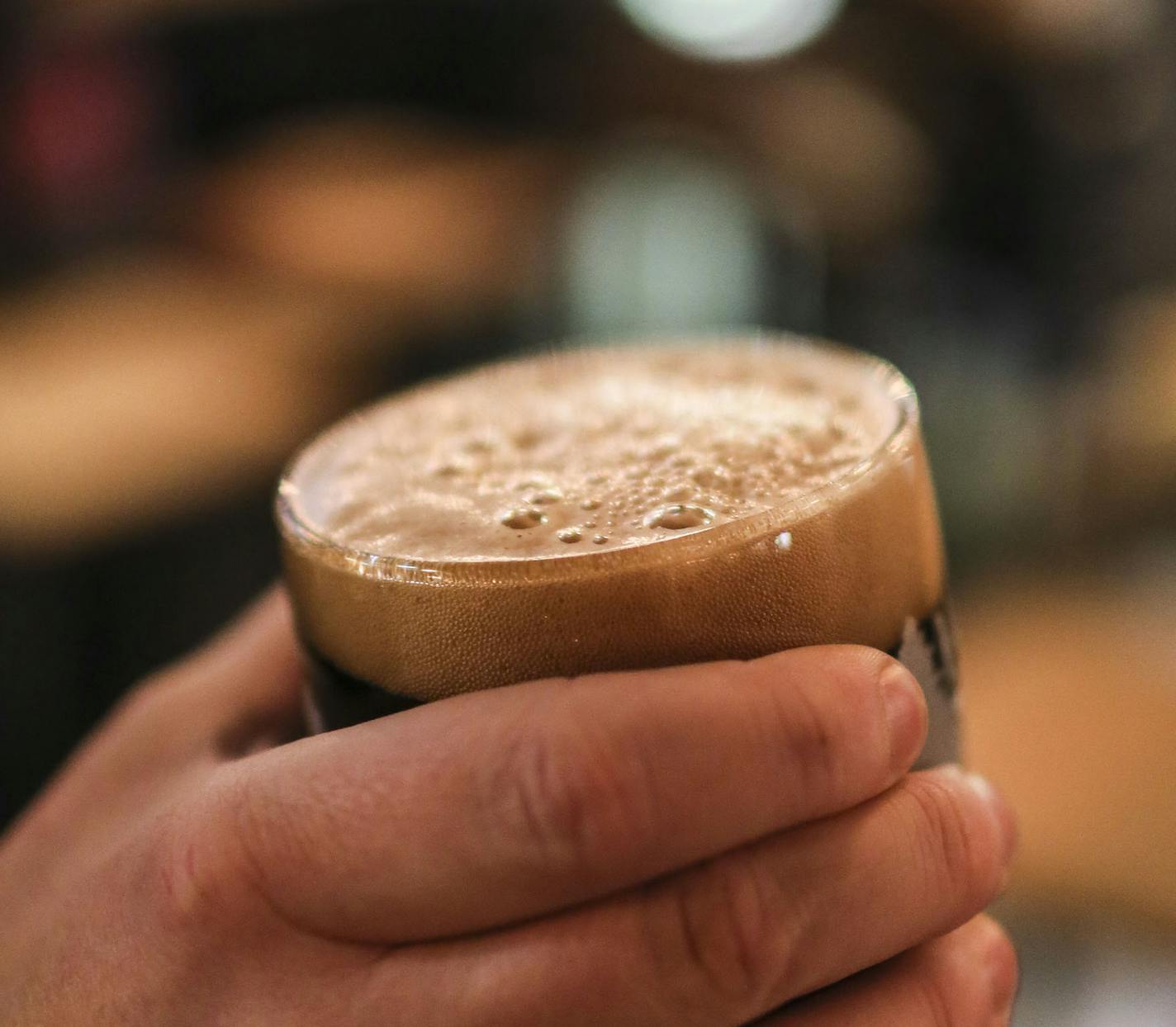 A customer has a tight grip on his fresh draw of Slop City, an American Rye Stout, at Eastlake Craft Brewery in the Midtown Global Market Friday, Dec. 12, 2014, in Minneapolis, MN. ](DAVID JOLES/STARTRIBUNE)djoles@startribune.com Eastlake Craft Brewery in the Midtown Global Market is the newest brewery and boasts craftsman-brewed ales and lagers and has a prominent location.