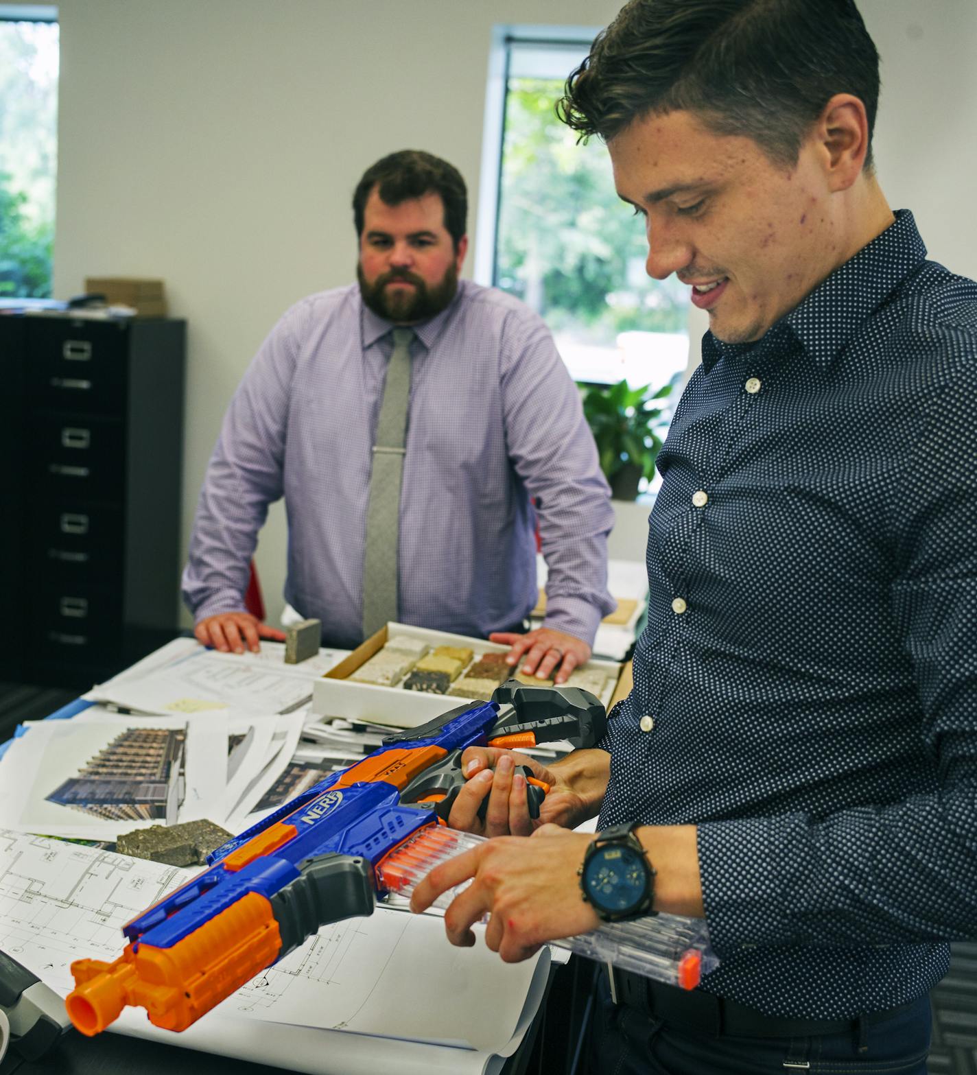 Architect Petro Merits loads up for the next nerf gun battle. Employees at Kaas Wilson Architects enjoy perks that make work more "fun."]Richard Tsong-Taatarii/rtsong-taatarii@startribune.com