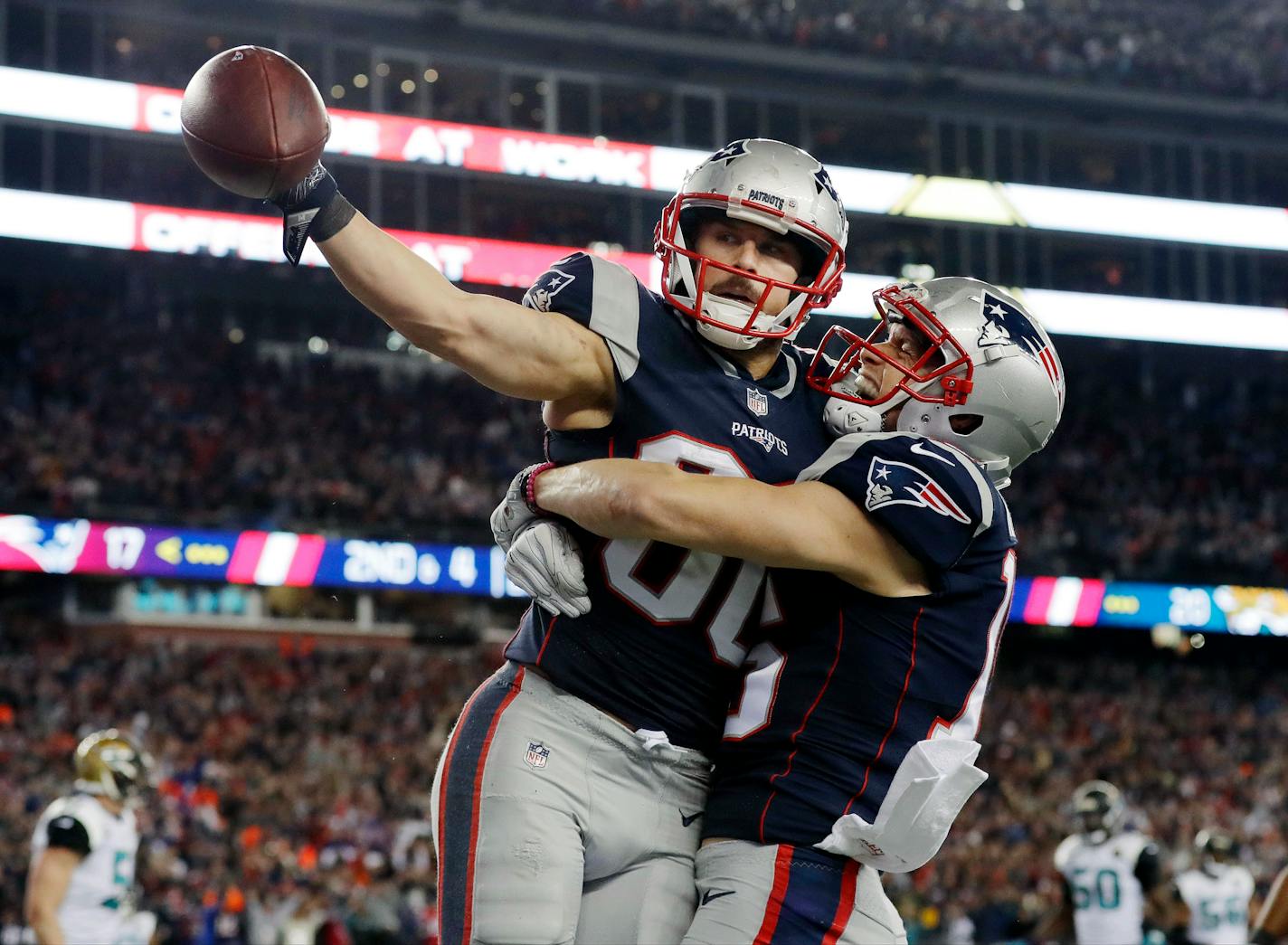 New England Patriots wide receiver Danny Amendola, left, celebrates his touchdown catch with Chris Hogan, right, during the second half of the AFC championship