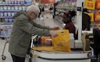A customer buys shopping at a till in the Sainsbury's flagship store in the Nine Elms area of London, Monday, April 30, 2018. Sainsbury's has agreed t