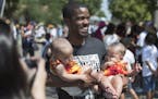 St. Paul mayoral candidate Melvin Carter held 6 -month -old twin sister Zonea Vreeland left and Zaria Vreeland while campaigning with supporters in th