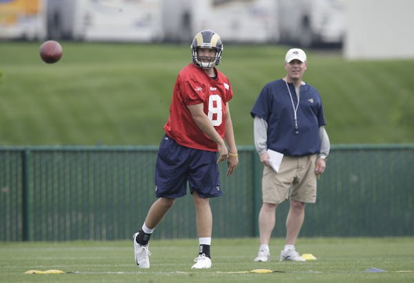 St. Louis Rams quarterback Sam Bradford throws as offensive coordinator Pat Shurmur looks on during rookie football mini-camp Friday, April 30, 2010, 
