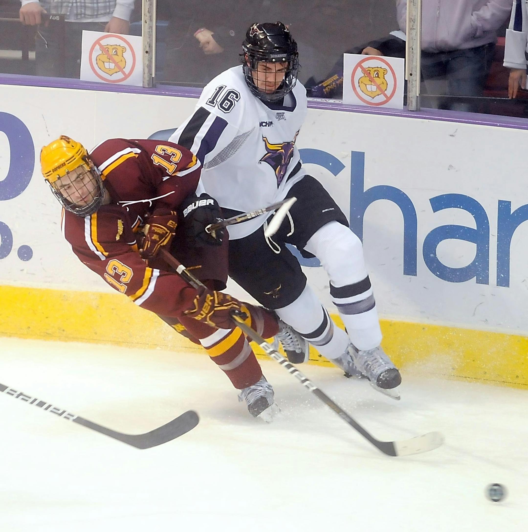 Minnesota's Nico Sacchetti and Minnesota State Mankato's Tyler Elbrecht battle for the puck during the second period of a NCAA college hockey game, Friday, Dec. 3, 2010, in Mankato. (AP Photo/Mankato Free Press, Pat Christman)