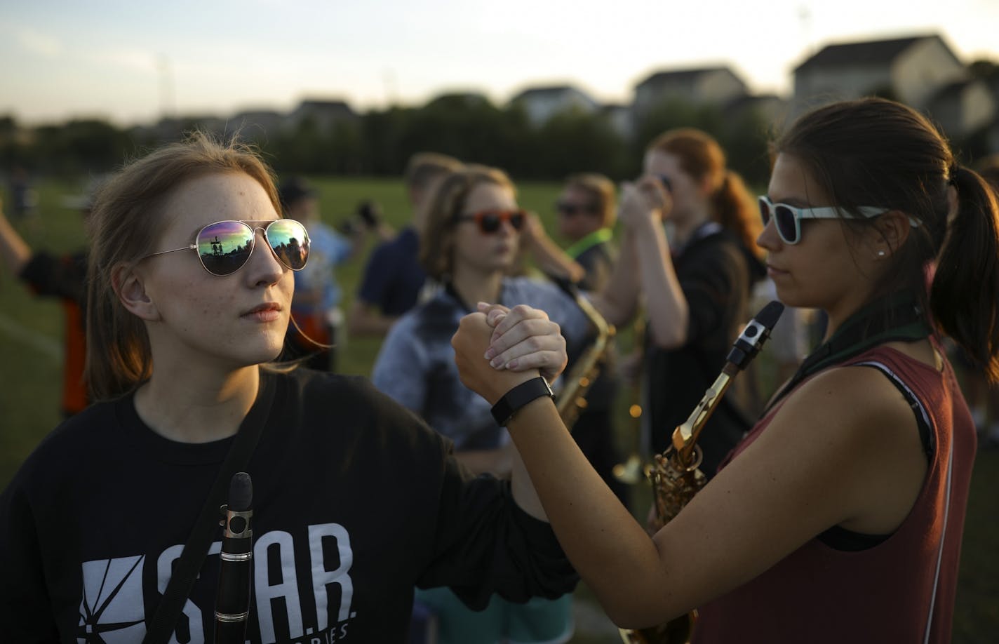 Farmington High School marching band members rehearsed clasping hands at the end of their program, "Dystopia" Thursday night at the school.