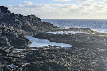 Volcanic cliffs form Los Charcones (natural pools) on the western coast of Lanzarote, Canary Islands.