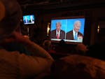 People watch the debate between Donald Trump and President Joe Biden in San Francisco on June 27.
