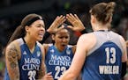 Lynx Olympians Seimone Augustus, left, Maya Moore and Lindsay Whalen celebrated during the victory over Seattle on Sunday at Target Center.