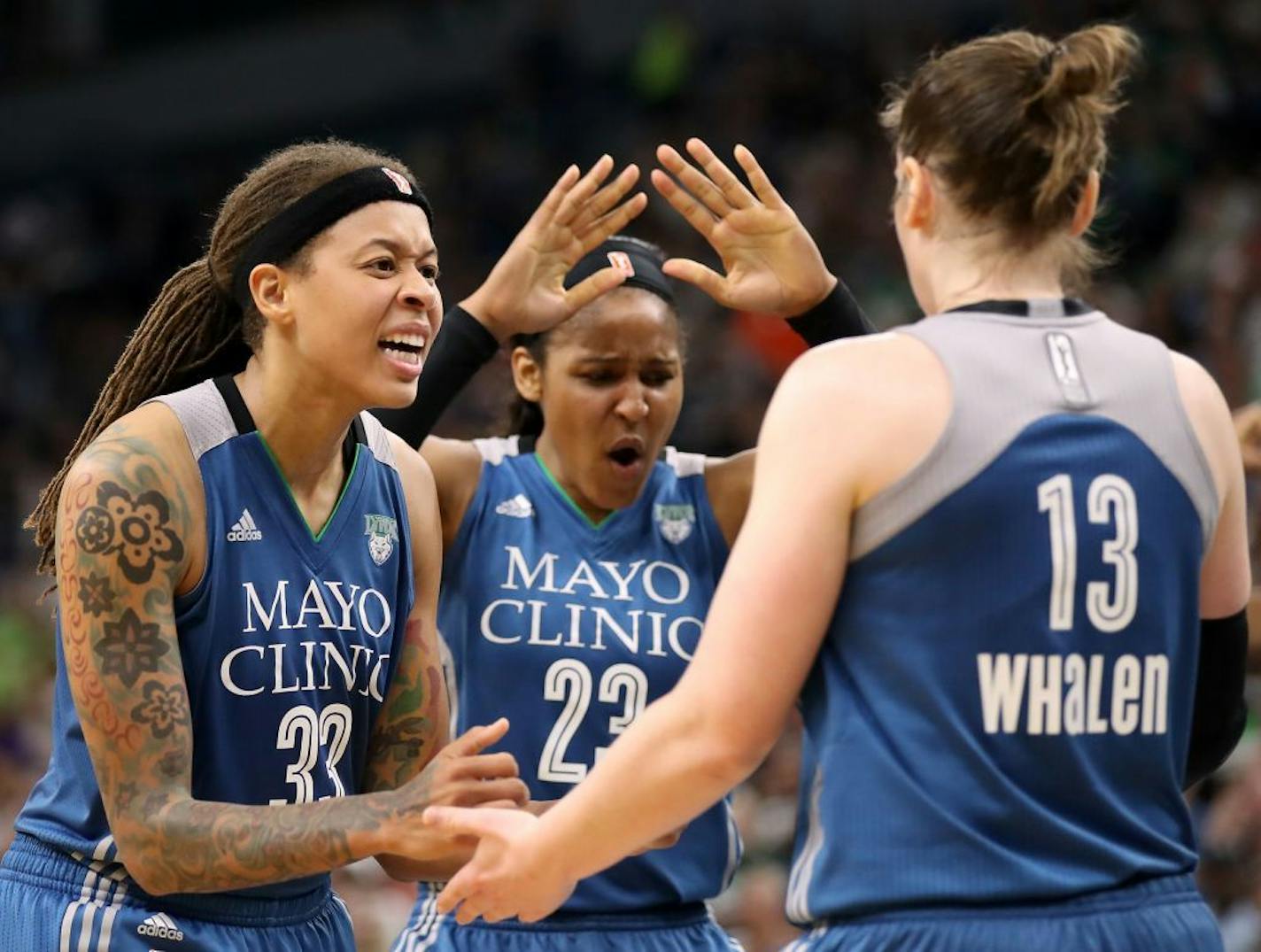 Lynx Olympians Seimone Augustus, left, Maya Moore and Lindsay Whalen celebrated during the victory over Seattle on Sunday at Target Center.