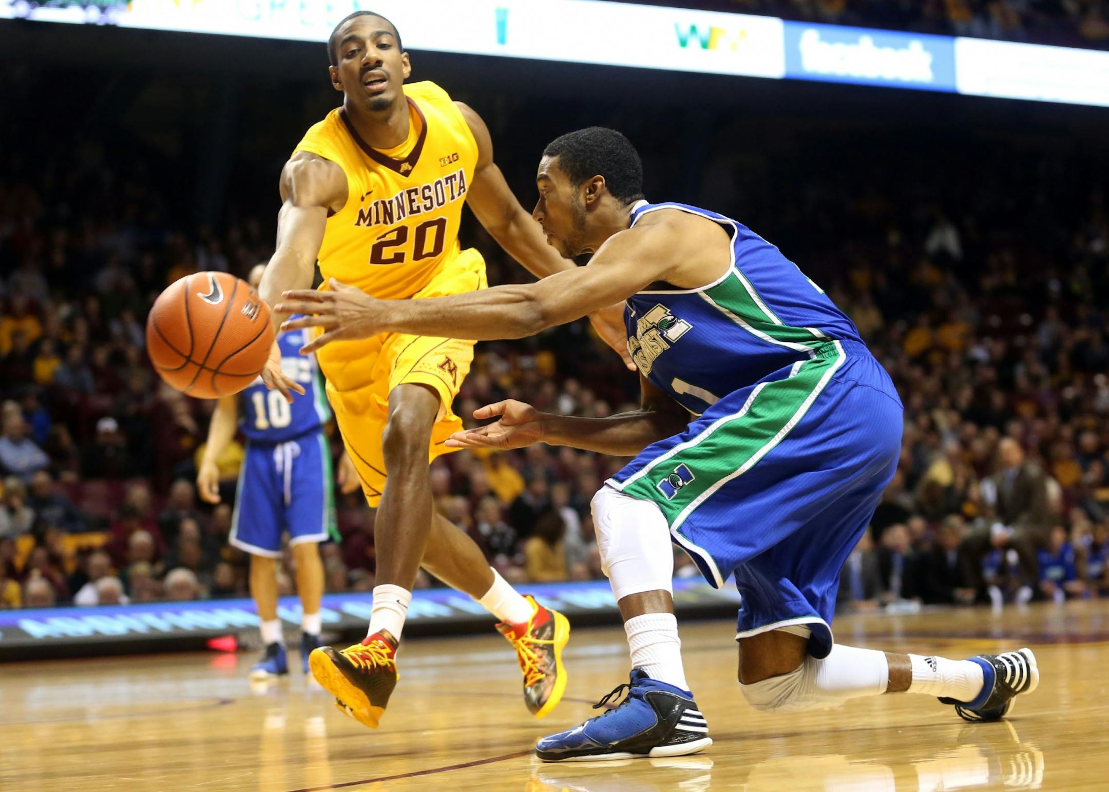 Gophers Austin Hollins attempted to steal the ball away from TAMCC's Jelani Currie during the first half at Williams Arena in Minneapolis Saturday, December 28, 2013.