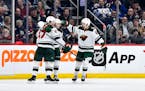 Minnesota Wild's Marco Rossi, center, celebrates his goal against the Winnipeg Jets with Declan Chisholm (47) and Frederick Gaudreau (89) during the s