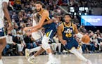 Rudy Gobert (27) set a screen for Donovan Mitchell during the Jazz’ victory over the Timberwolves on Dec. 23.