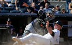 New York Yankees' Brian McCann, right, is tagged out at home plate by Minnesota Twins catcher Kurt Suzuki during the eighth inning of a baseball game 