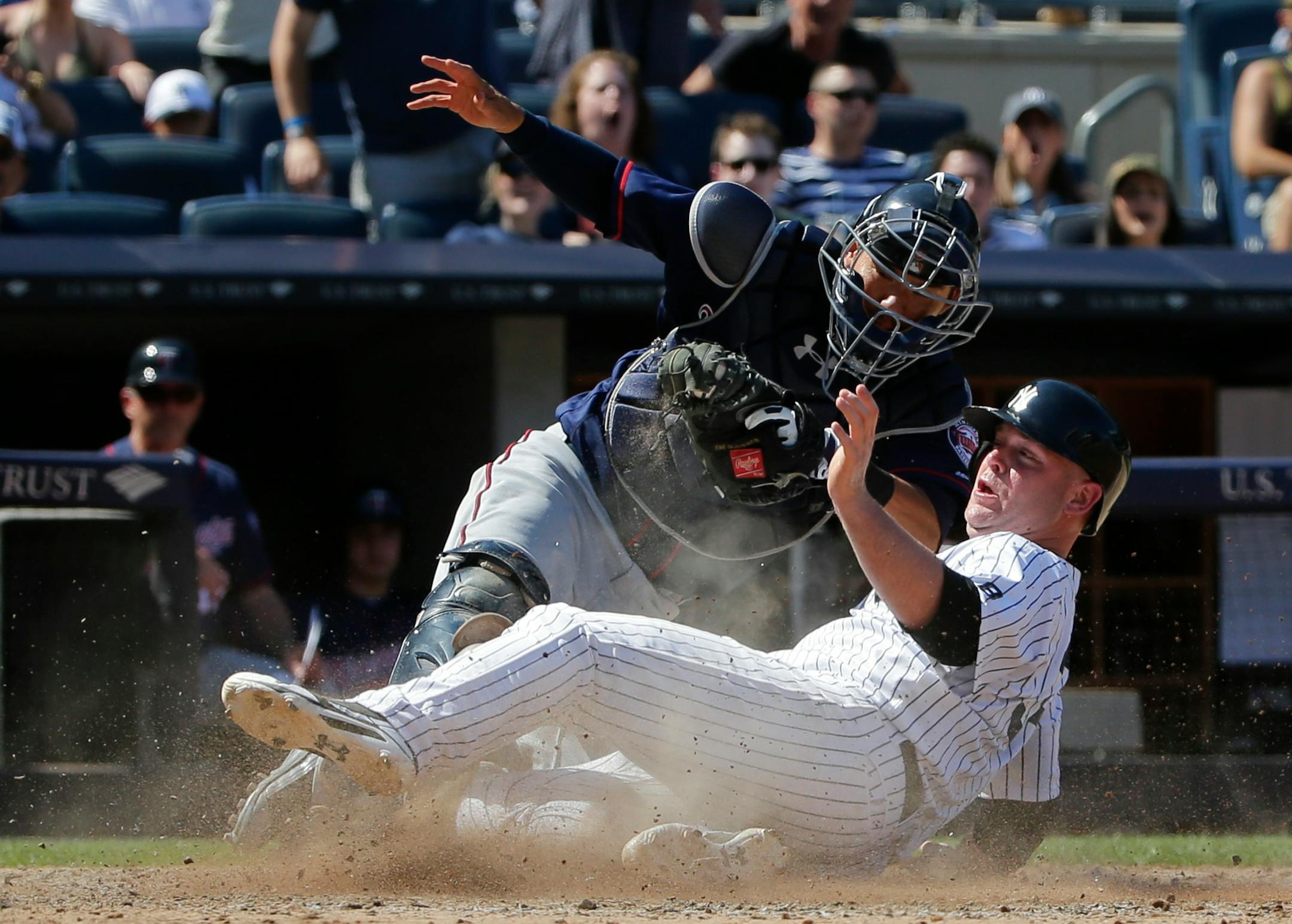 New York Yankees' Brian McCann, right, is tagged out at home plate by Minnesota Twins catcher Kurt Suzuki during the eighth inning of a baseball game Saturday, June 25, 2016, in New York. The Yankees won 2-1. (AP Photo/Frank Franklin II)