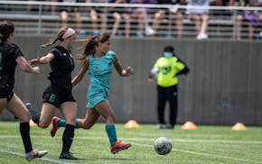 Minnesota Aurora' Mariah Nguyen pushed the ball up the field past Lions' Kelsey Kehoe, en route to scoring in the first half.