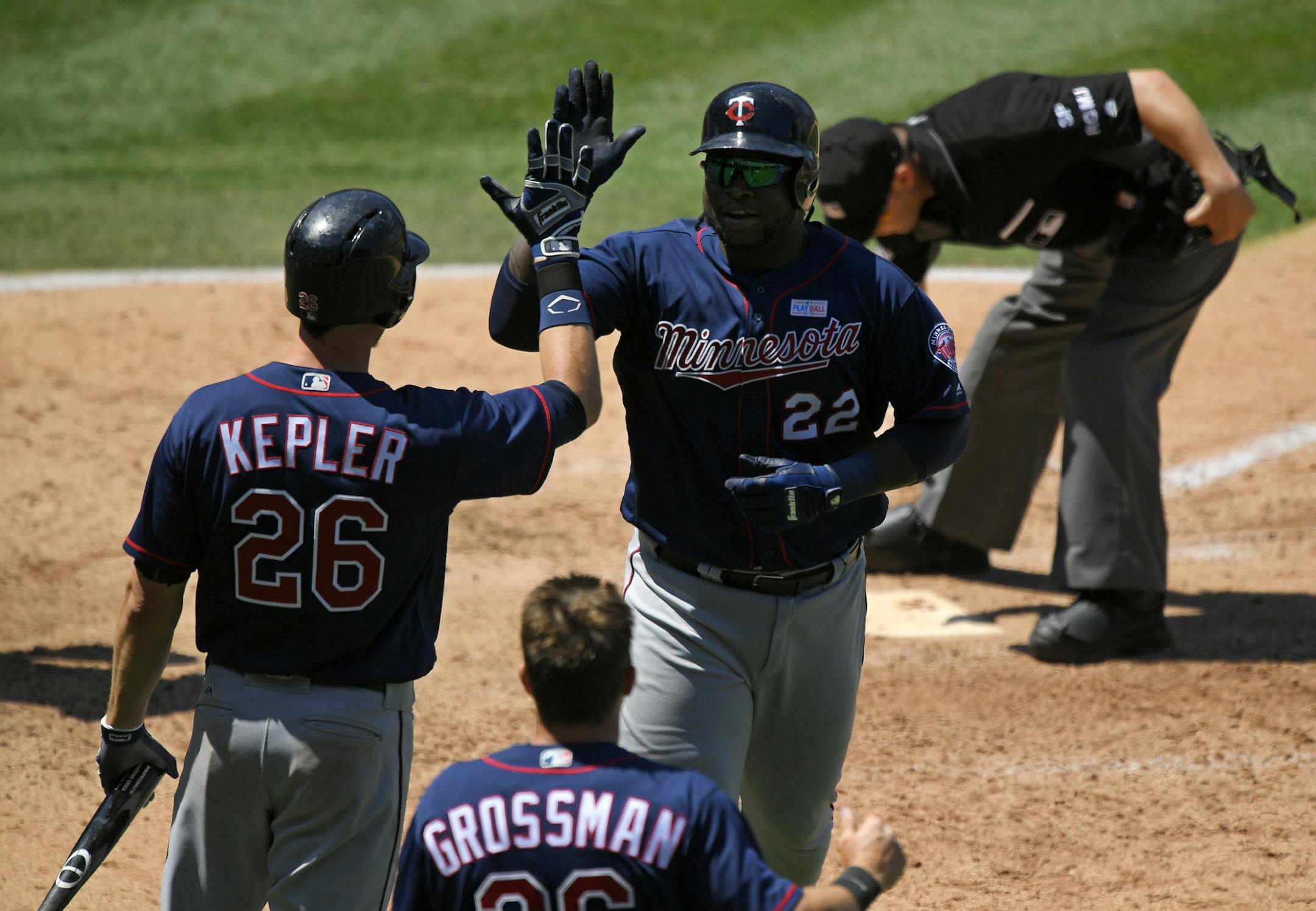 The Twins’ Miguel Sano, right, was congratulated by Max Kepler, left, and Robbie Grossman after hitting a two-run homer during the sixth inning against the Los Angeles Angels on Sunday.