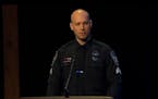 Burnsville Sgt. Adam Medlicott speaks during a memorial service for fellow first responders killed during a standoff.
