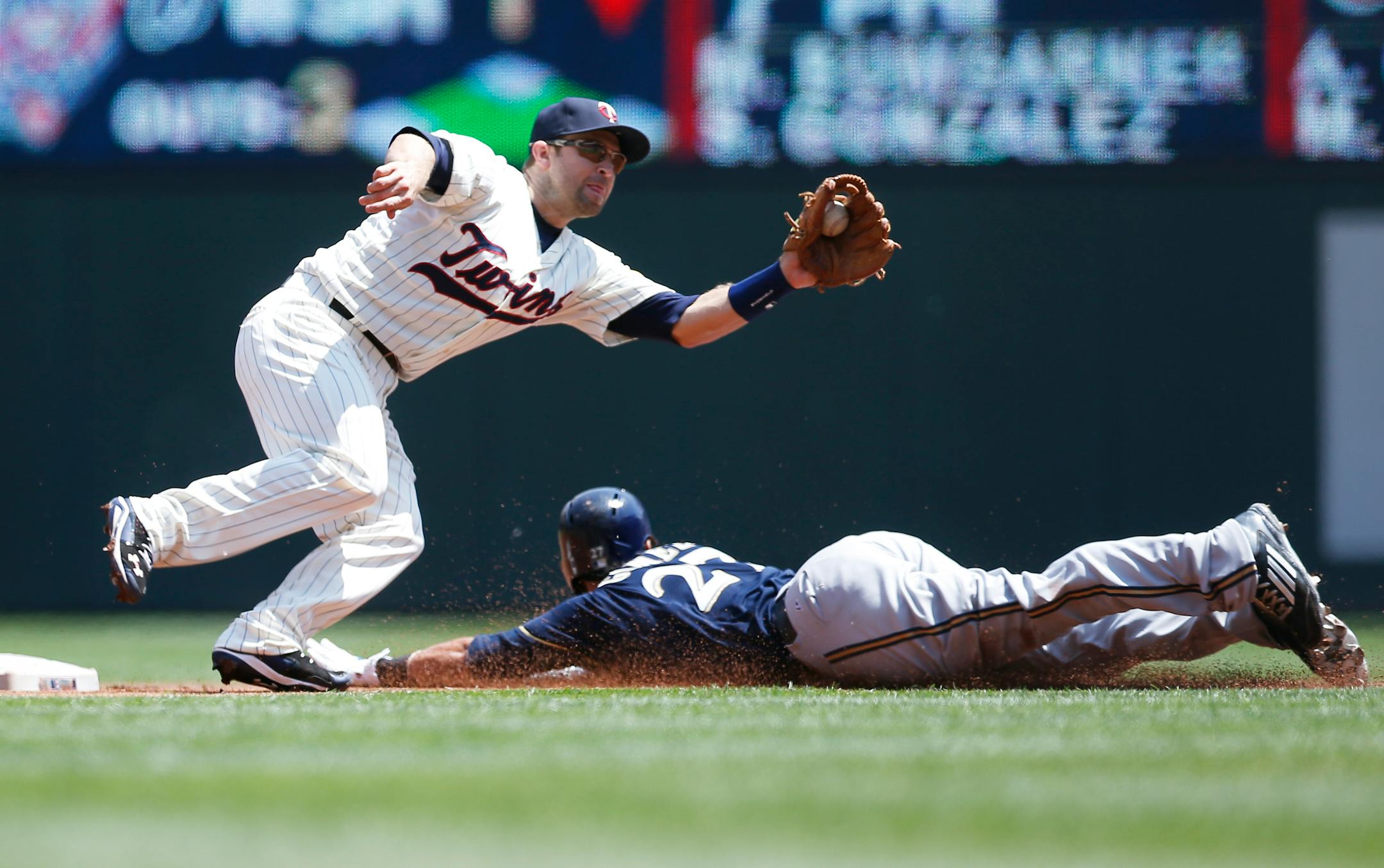 Milwaukee Brewers' Carlos Gomez, right, steals second base on Minnesota Twins second baseman Brian Dozier in the first inning of a baseball game, Saturday, June 6, 2015, in Minneapolis. (AP Photo/Jim Mone)