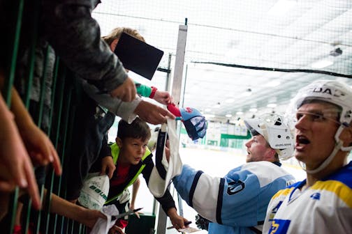 Nick Bjugstad of the Florida Panthers and Zane McIntyre (second from right) sign autographs for children after their Da Beauty League game, on Monday night. ] COURTNEY PEDROZA &#x2022; courtney.pedroza@startribune.com; Da Beauty League; top professional hockey players who live in Minnesota play in Da Beauty League at Braemar Arena; Monday 08/07/2017; Edina