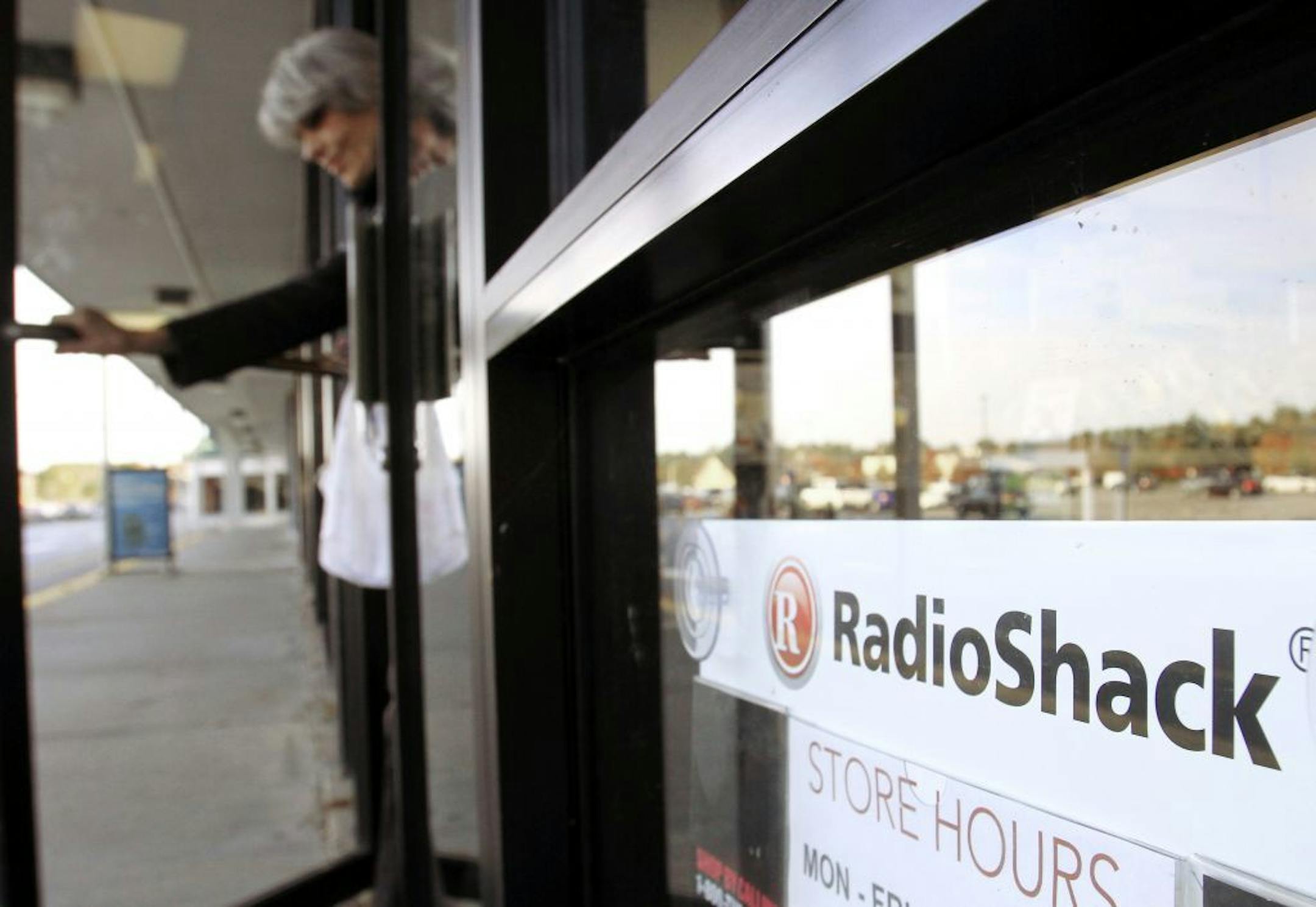 FILE - In this Wednesday, Oct. 20, 2010 photo, a shopper leaves a RadioShack store in Brunswick, Maine.