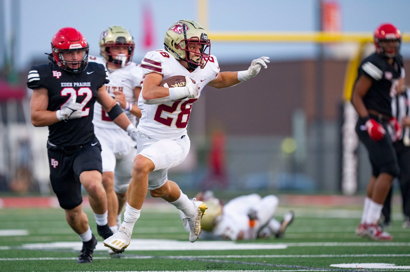 Lakeville South running back Carson Hansen (28) runs the ball against Eden Prairie in the first quarter Friday, September 16, 2022 at Eden Prairie High School in Eden Prairie, Minn. ]