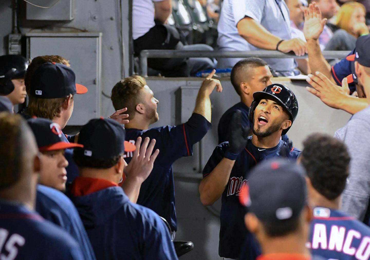 Minnesota Twins' Eddie Rosario, right, celebrates in the dugout after he hit a two-run home run against the Chicago White Sox during the sixth inning of a baseball game in Chicago on Tuesday, Aug. 22, 2017. (AP Photo/Matt Marton)