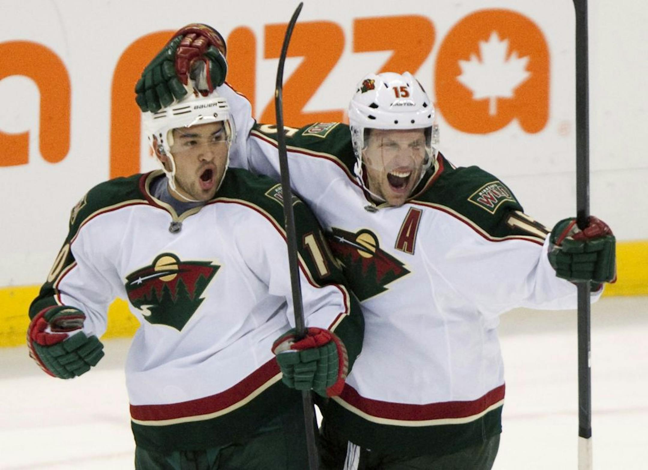 Minnesota Wild's Dany Heatley, right, congratulates teammate Devin Setoguchi on his goal against the Ottawa Senators during the first period of an NHL hockey game in Ottawa on Tuesday , Oct. 11, 2011.