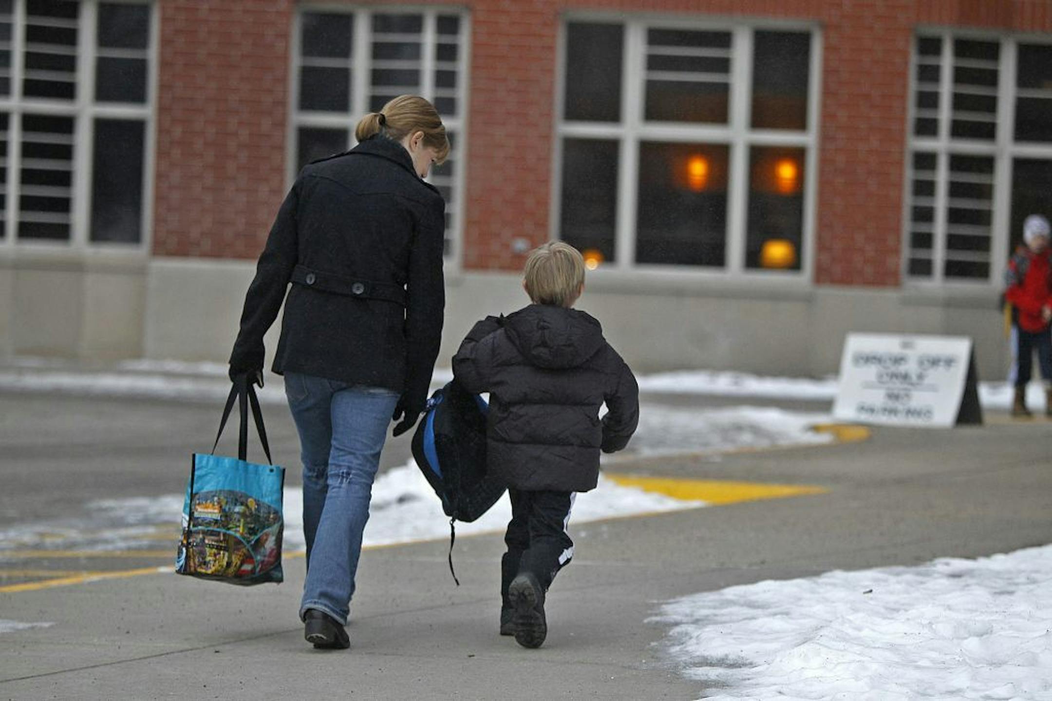 Michele Peters walked her son Logan to kindergarten class at Burroughs Community School in Minneapolis.