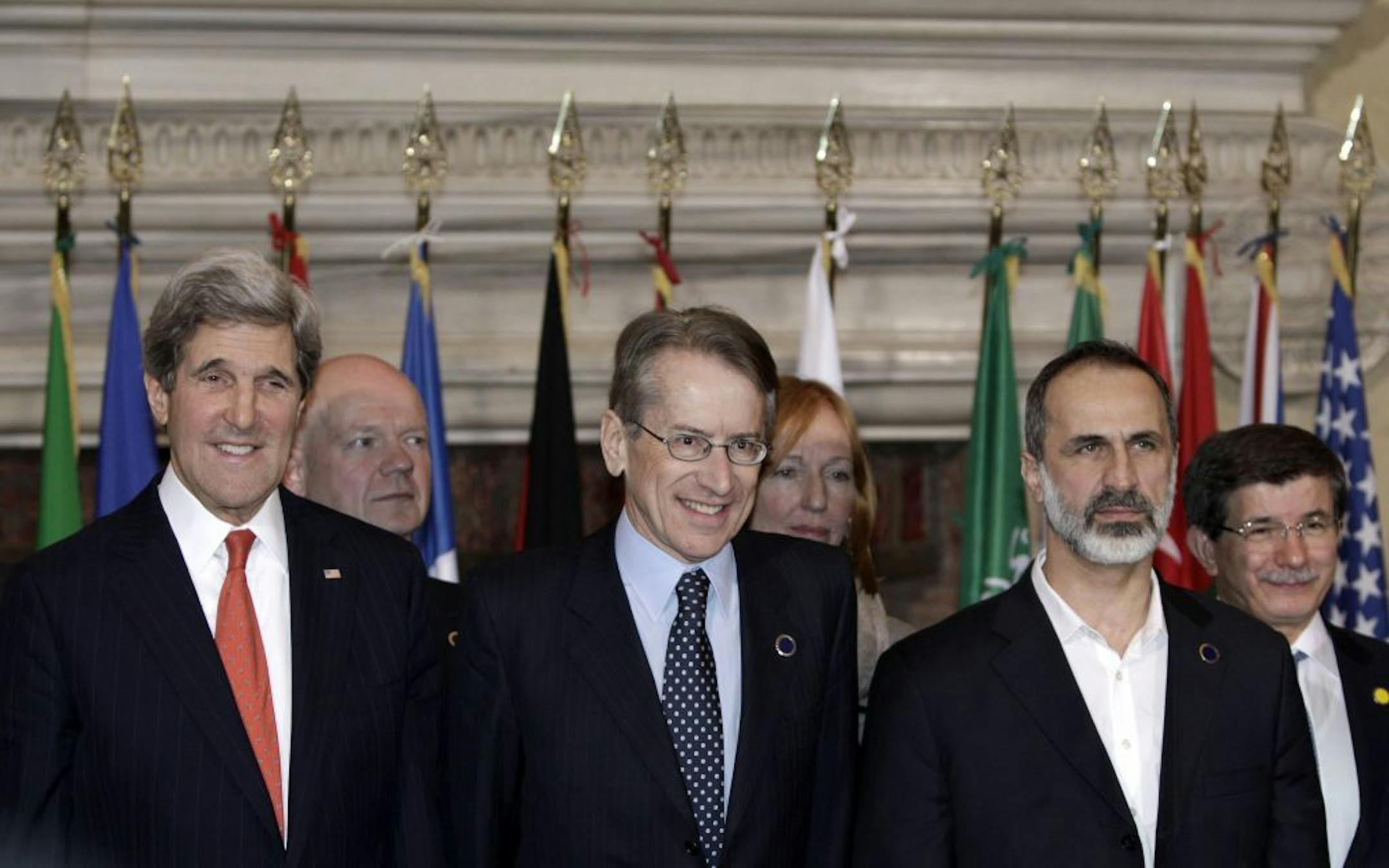 From left, U.S. Secretary of State John Kerry, Italian Foreign Minister Giulio Terzi and Syrian opposition leader Mouaz al-Khatib pose for a family photo during a meeting on Syria at Villa Madama, Rome on Feb. 28, 2013.