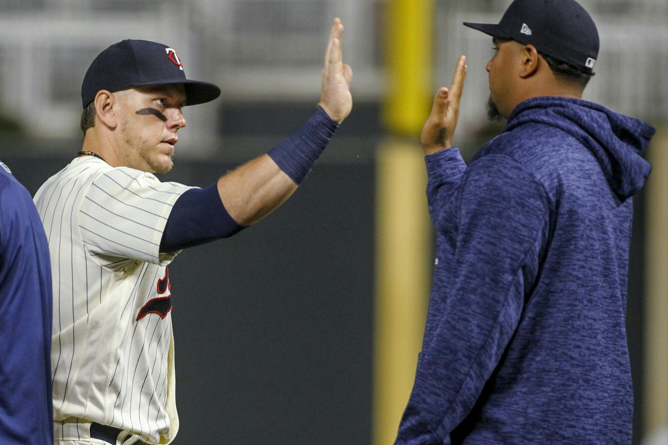 Minnesota Twins first baseman Logan Morrison celebrates with Adalberto Mejia, right, after the 8-2 win over the Kansas City Royals in a baseball game Saturday, Aug. 4, 2018, in Minneapolis.